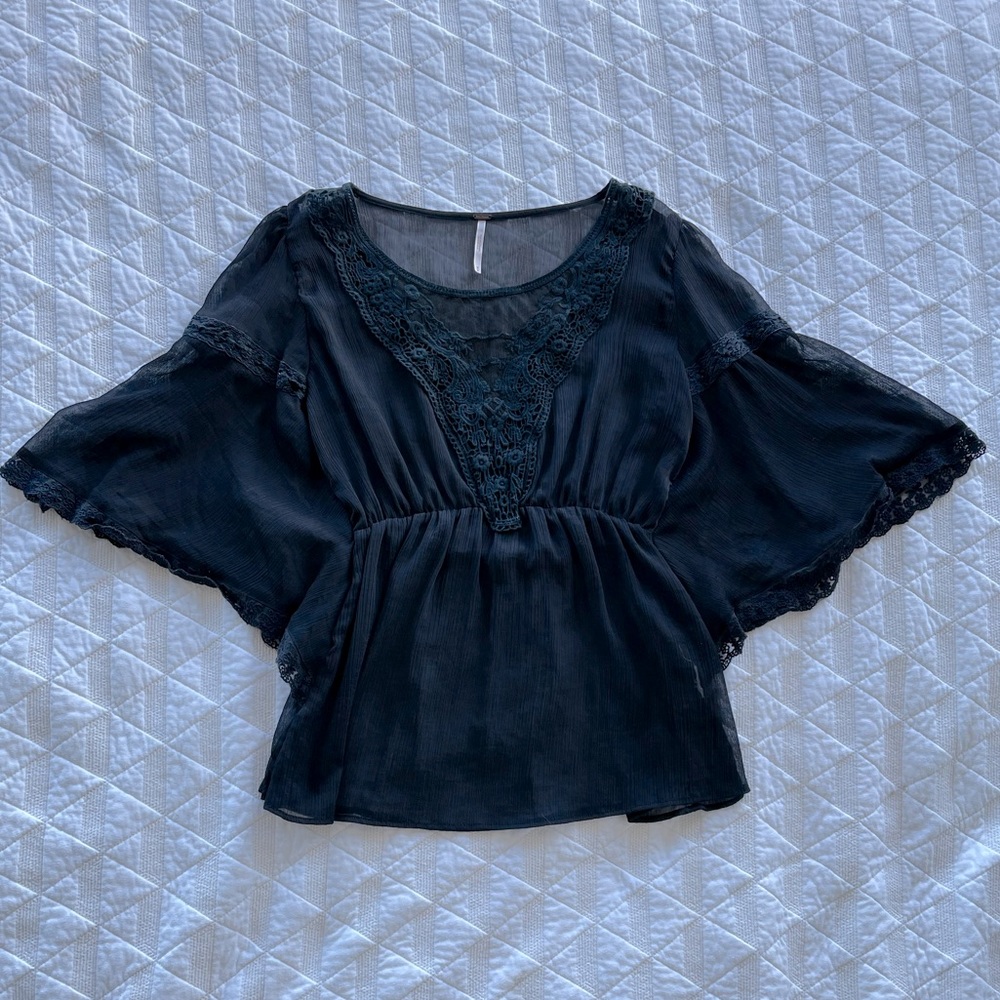 Sheer black top with lace crochet detailing